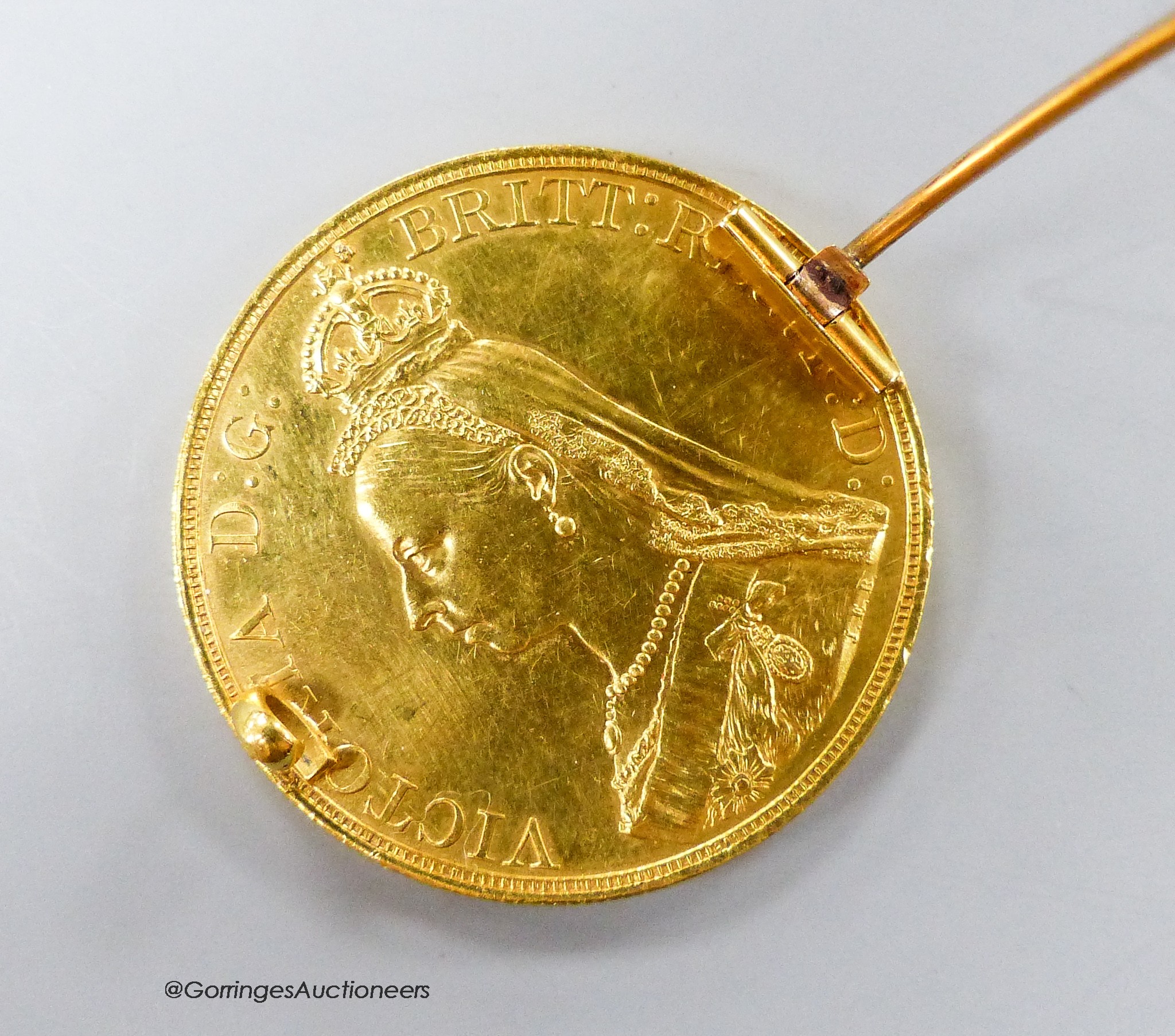 An 1887 £5 gold coin, now mounted as a brooch, gross 41.2 grams.